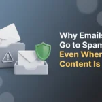 Envelope sliding into a grey folder marked with a warning triangle while a green shield guards a second envelope reaching the inbox, illustrating why emails go to spam